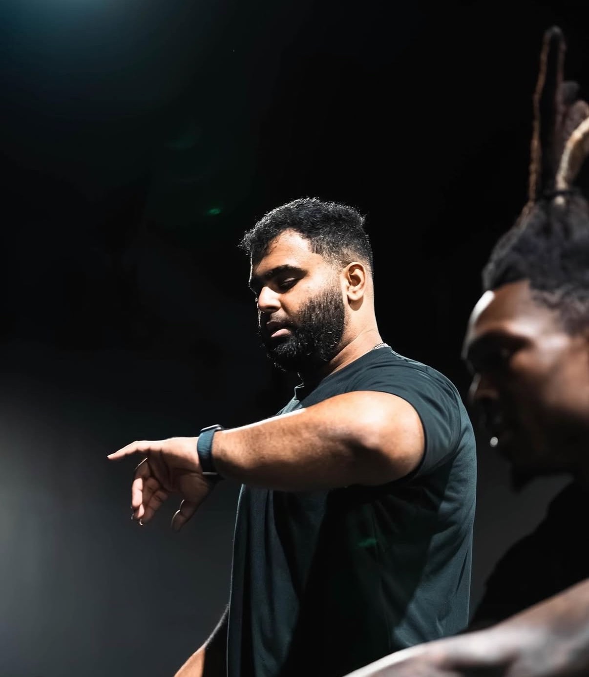 Raja Siddiqui guiding a client through movement during a performance session